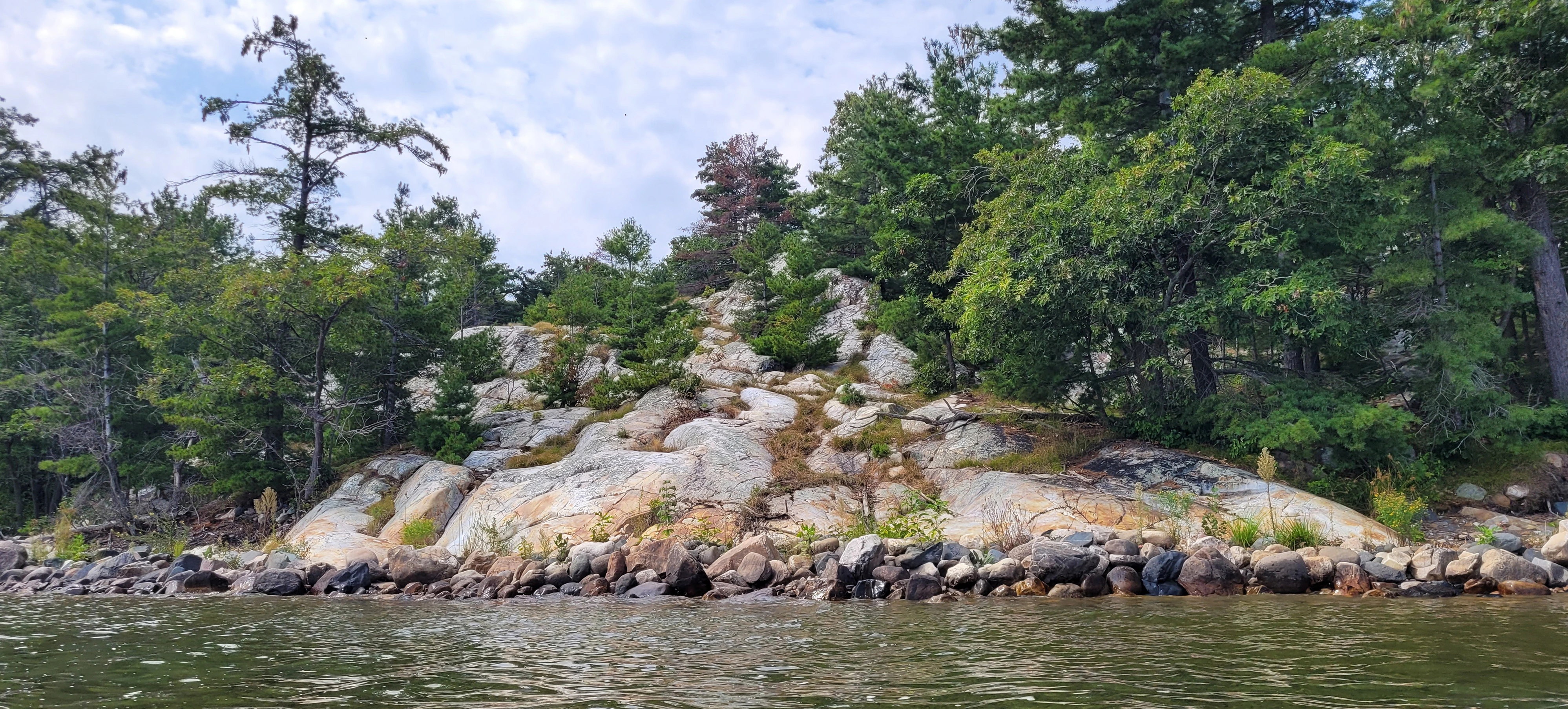Towering white quartzite cliffs in Killarney Bay Ontario Canada